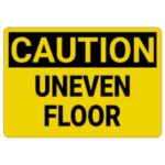 "Warning sign for uneven floor surface in commercial building"
