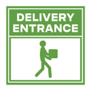 Green "Delivery Entrance" sign on a metal gate.