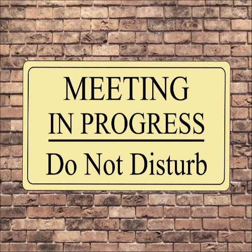 Informative "Meeting In Progress" sign in a Nigerian office lobby.