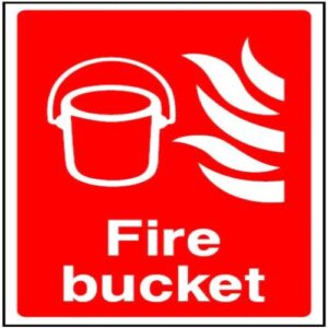 Red "Fire Bucket" sign prominently displayed at a Lagos construction site.